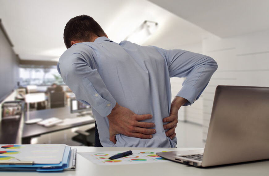 Office worker with desk job back pain – ergonomic posture tips from Dr. Makda