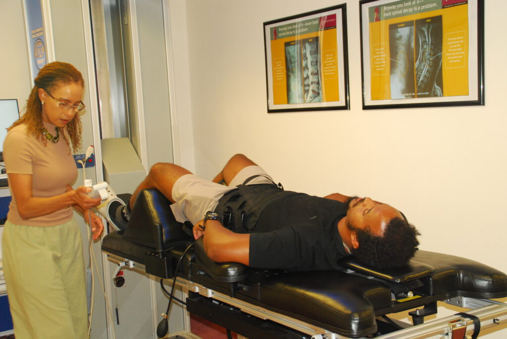 Dr Makda treating a patient with nonsurgical spinal decompression therapy at Makda Chiropractic Health Center best chiropractor near Me in Alexandria VA Natural Relief for Back Pain in Alexandria VA